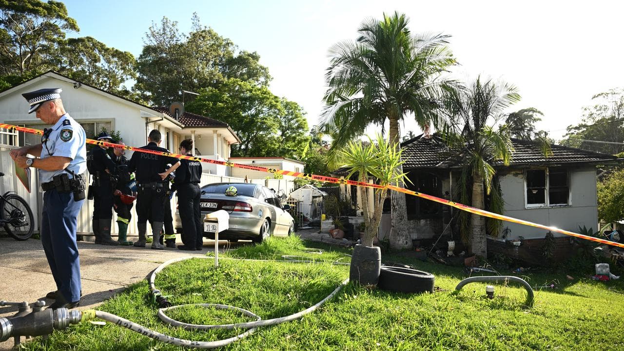 Police and fire investigators at scene of a house fire in Heckenberg