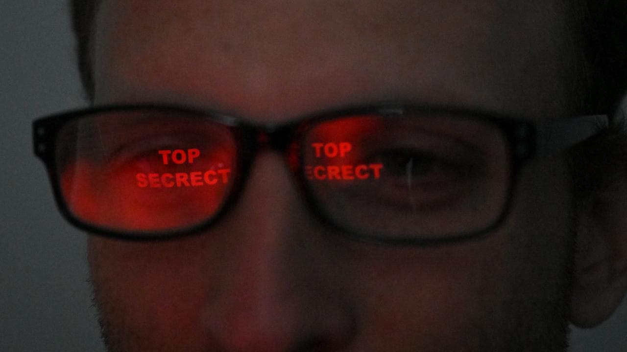 Illustrative photo of man viewing Top Secret material