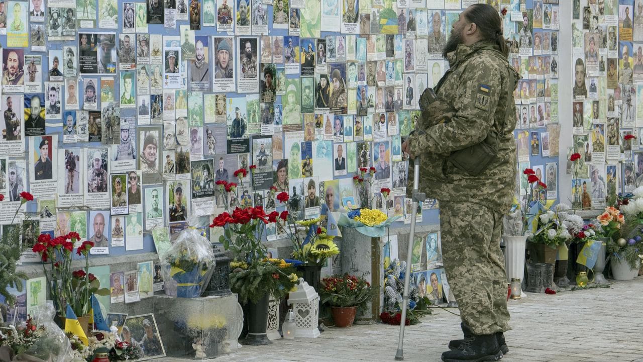 A serviceman mourns at a memorial in Kyiv (file image)