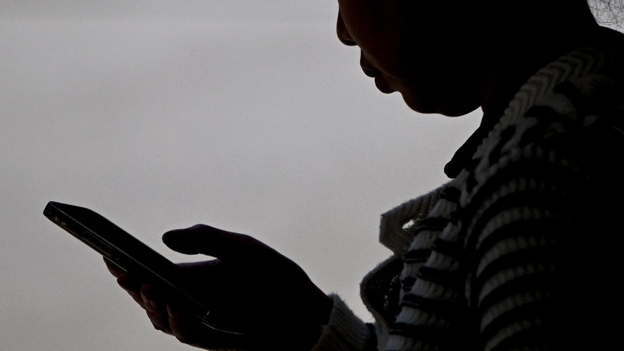 A woman seen using a smartphone device