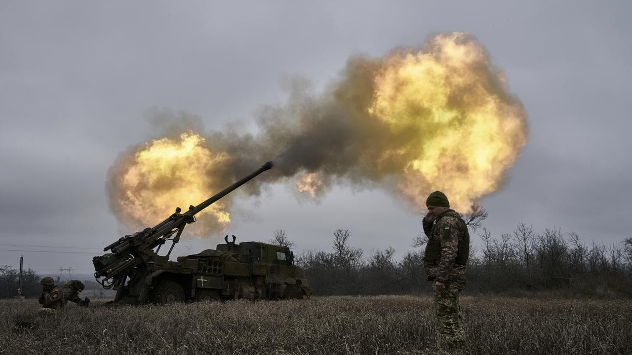 Ukrainian soldiers fire a self-propelled howitzer