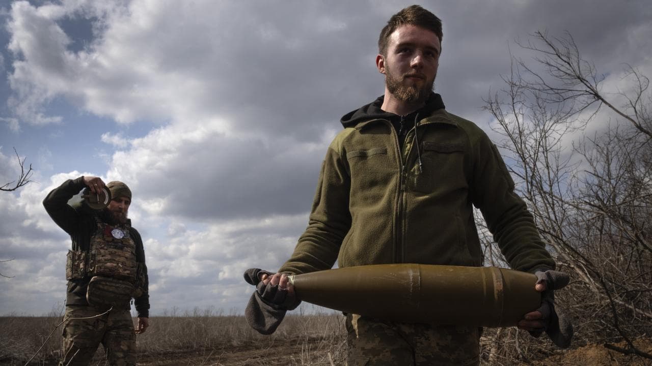 Ukrainian soldiers carry shells near Bakhmut in the Dontesk region