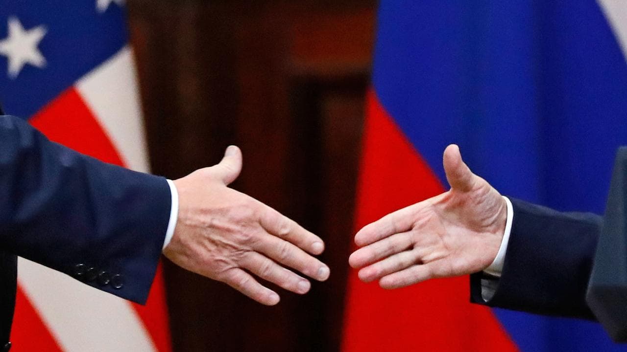Donald Trump shakes hands with Vladimir Putin (file image)