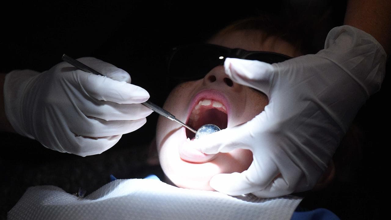 A young child during a dental exam in Sydney on Monday, March 21, 2016