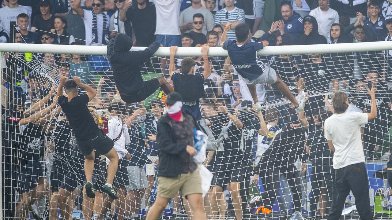 Melbourne Victory fans invade the pitch.