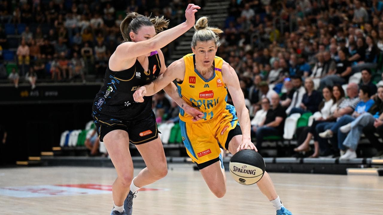 Sami Whitcomb (right) looks for a way past Nicole Munger