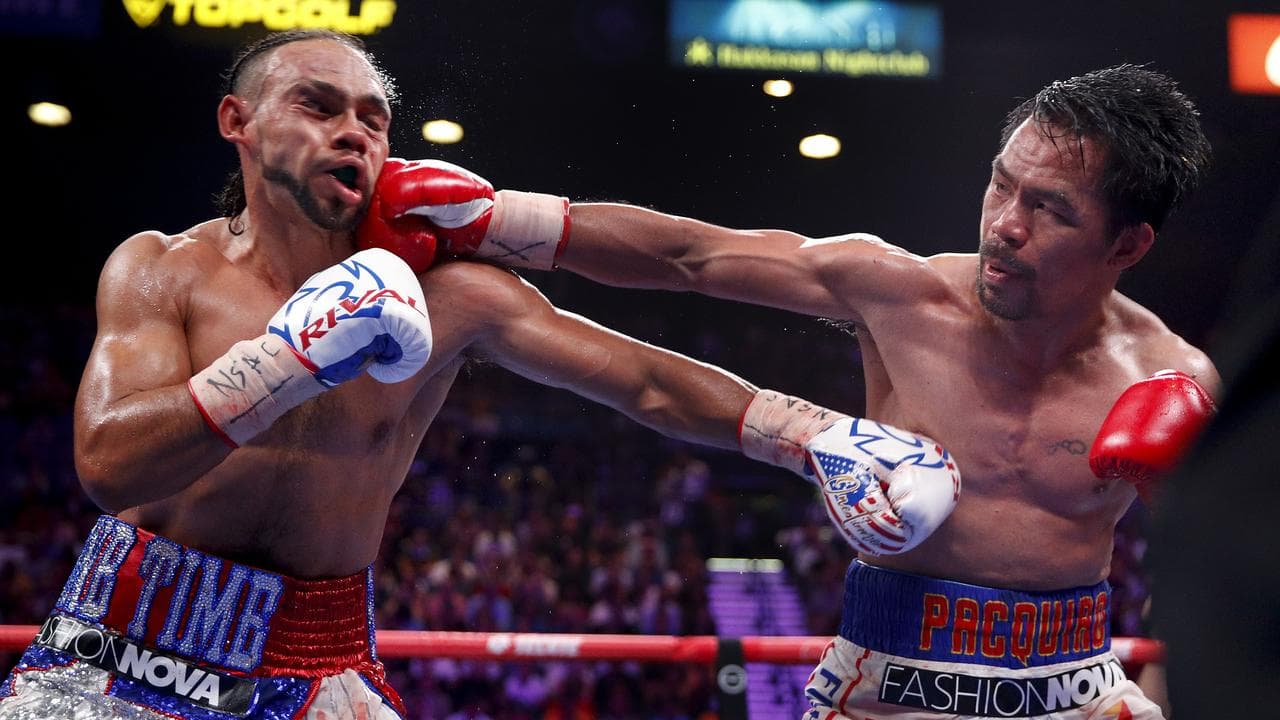 Manny Pacquiao, right, lands a punch against Keith Thurman