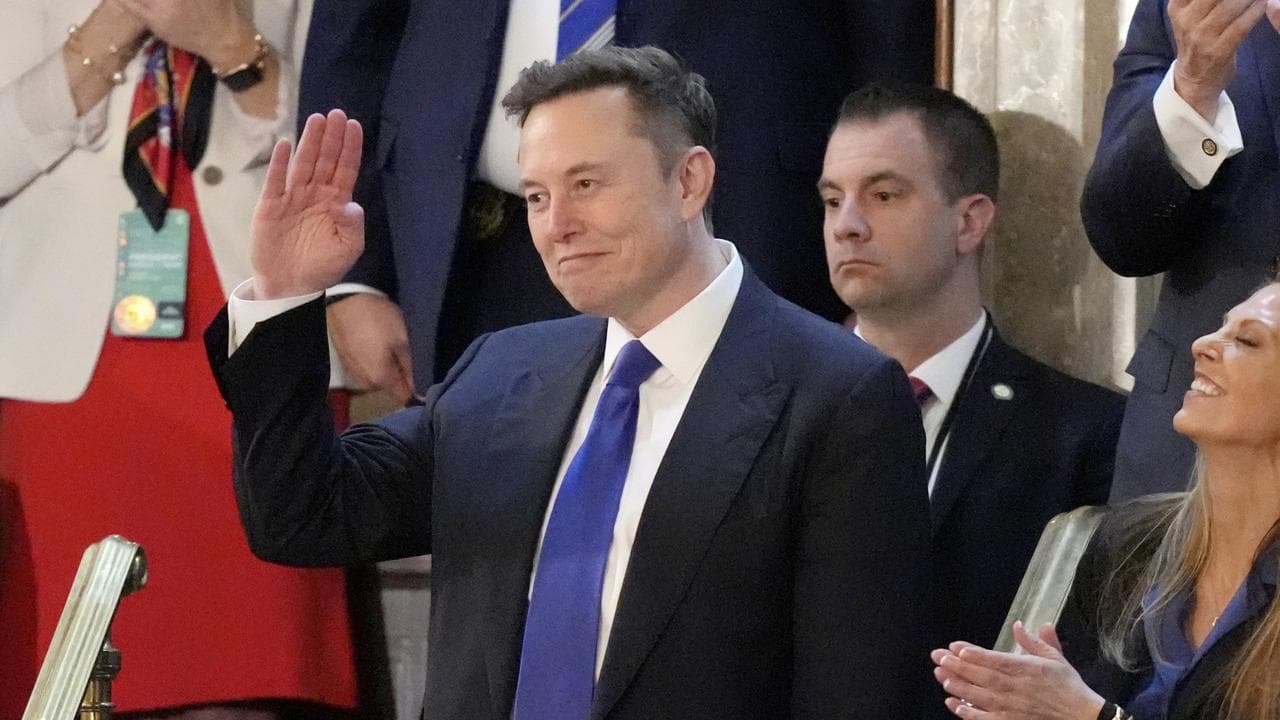 Elon Musk gestures as President Donald Trump addresses Congress