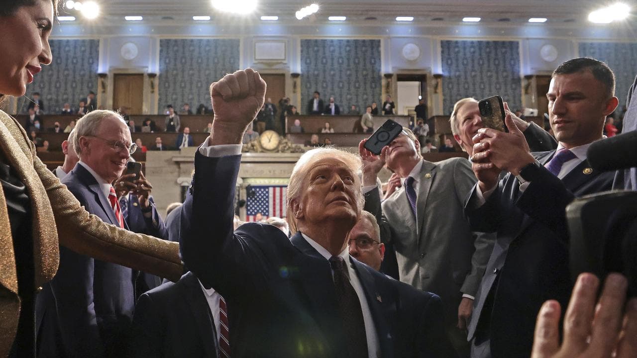 President Donald Trump leaves the House chamber after his speech
