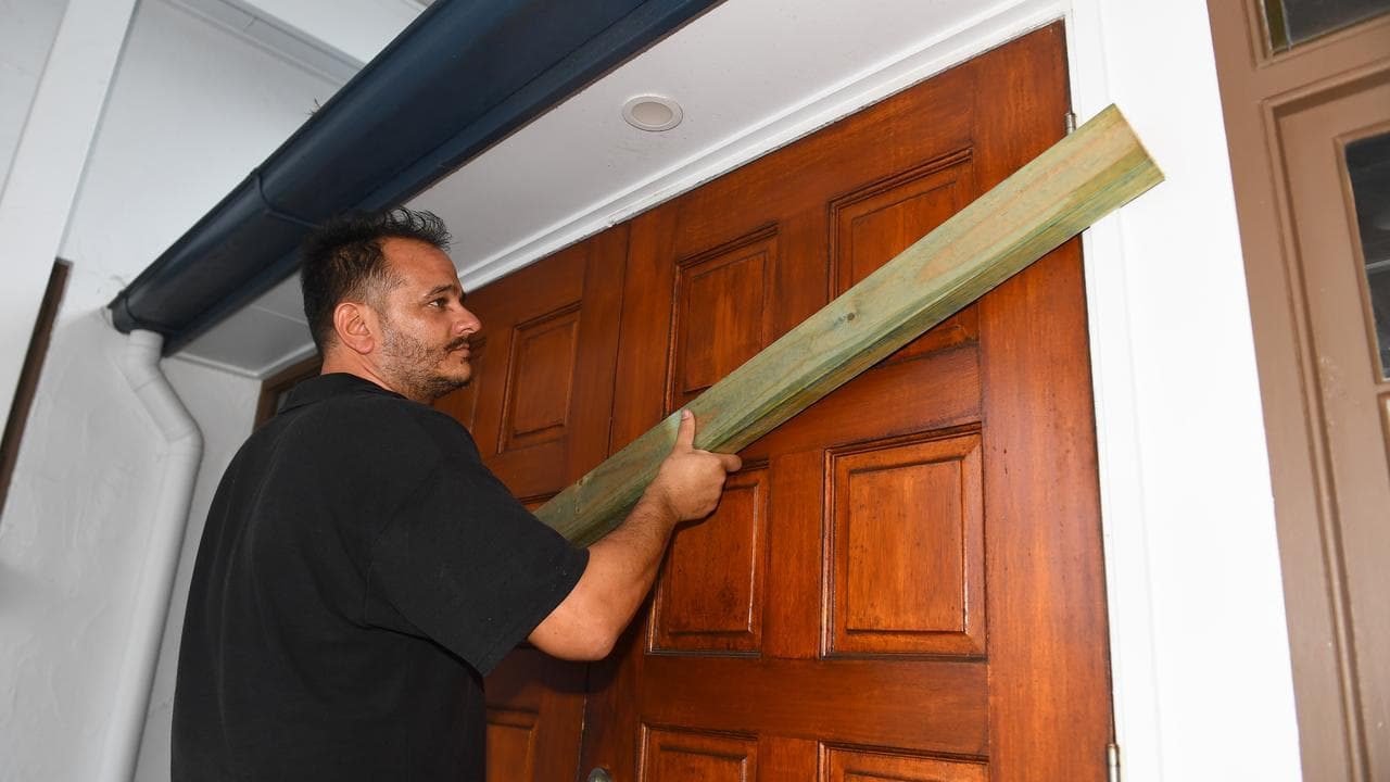 Restaurant general manager Tim Varitimous boards up a door