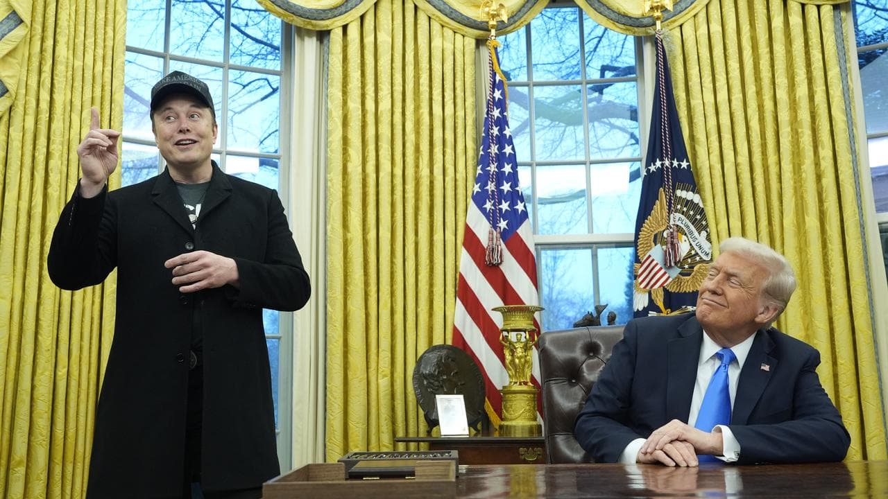 Donald Trump listens as Elon Musk speaks in the Oval Office, Feb 2025