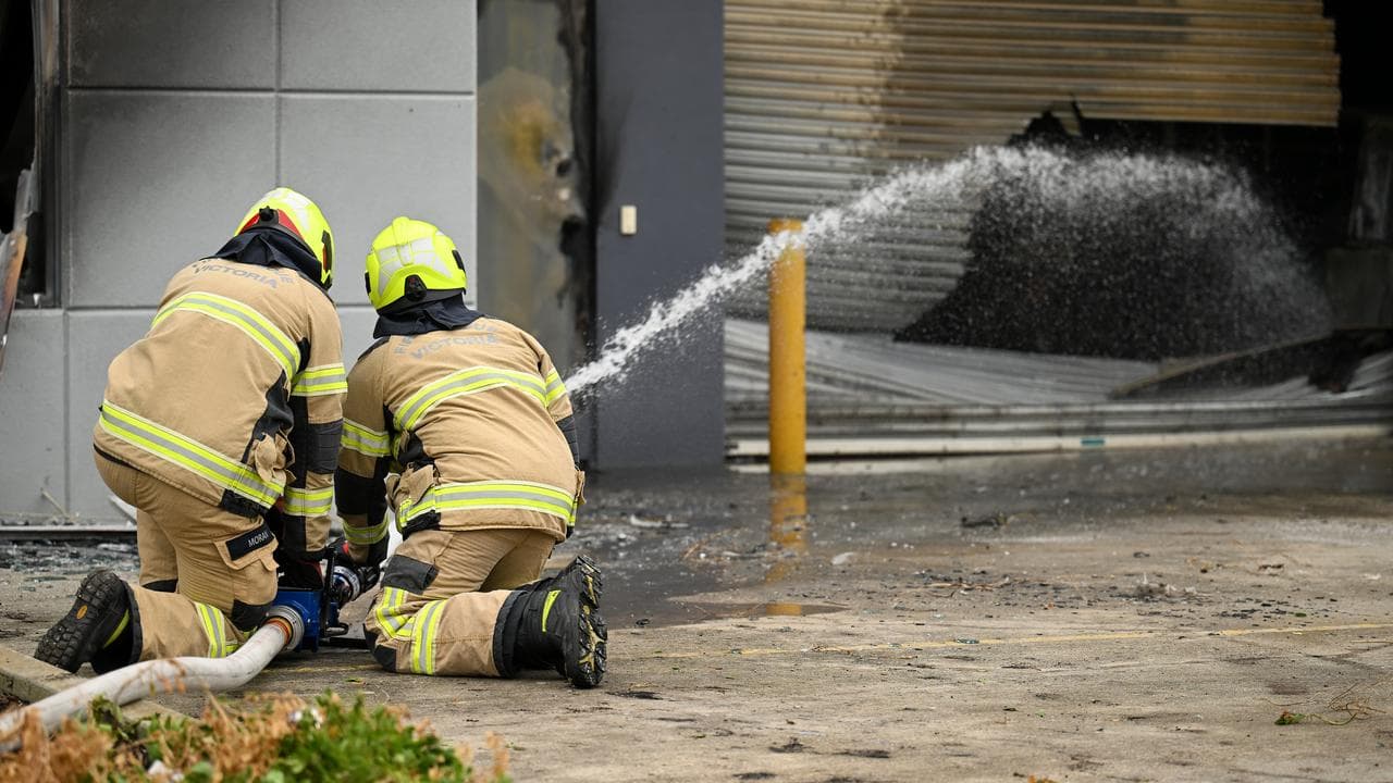 Fire crews work to extinguish flames.