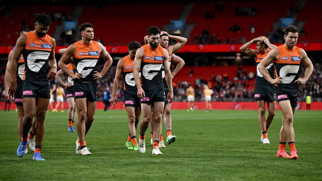 Giants players leave the field after their loss to Brisbane.