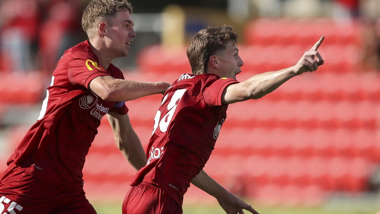 Adelaide United's Harry Crawford (right)