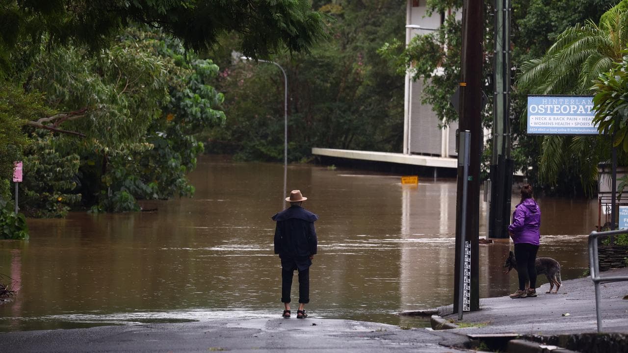 Residents looking at flooded streets in Lismore