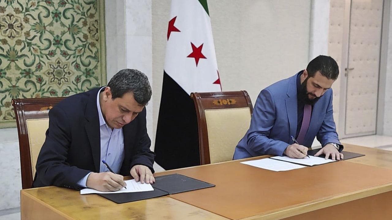 Syria's interim President Ahmad al-Sharaa, right, and Mazloum Abdi,