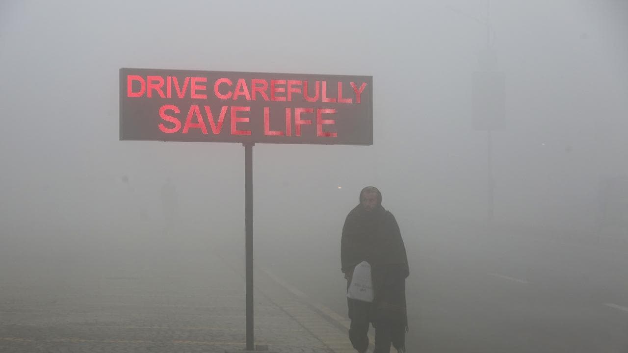 a sign that reads "Drive carefully save life" in Peshawar, Pakistan
