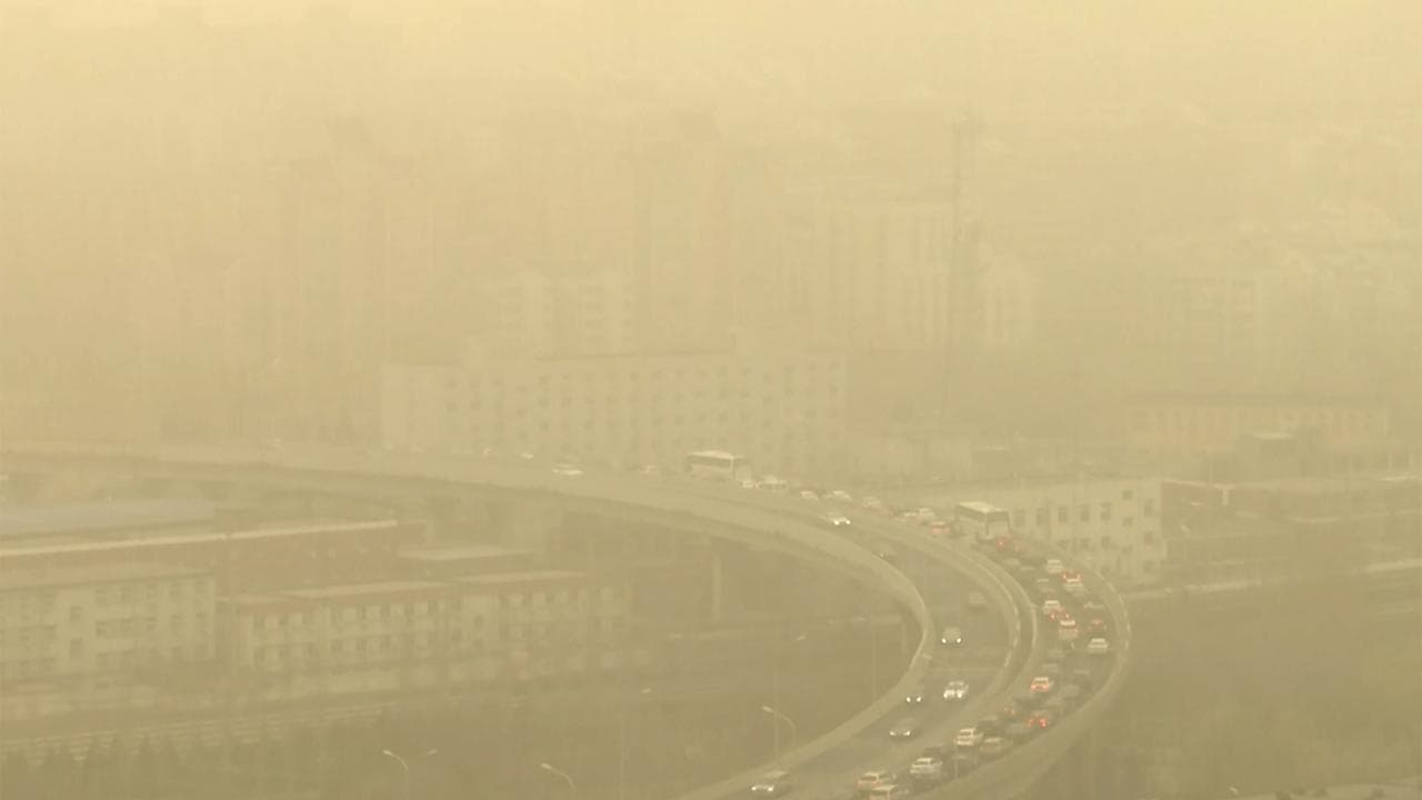 Cars on a highway during a dust storm amid heavy pollution in Beijing