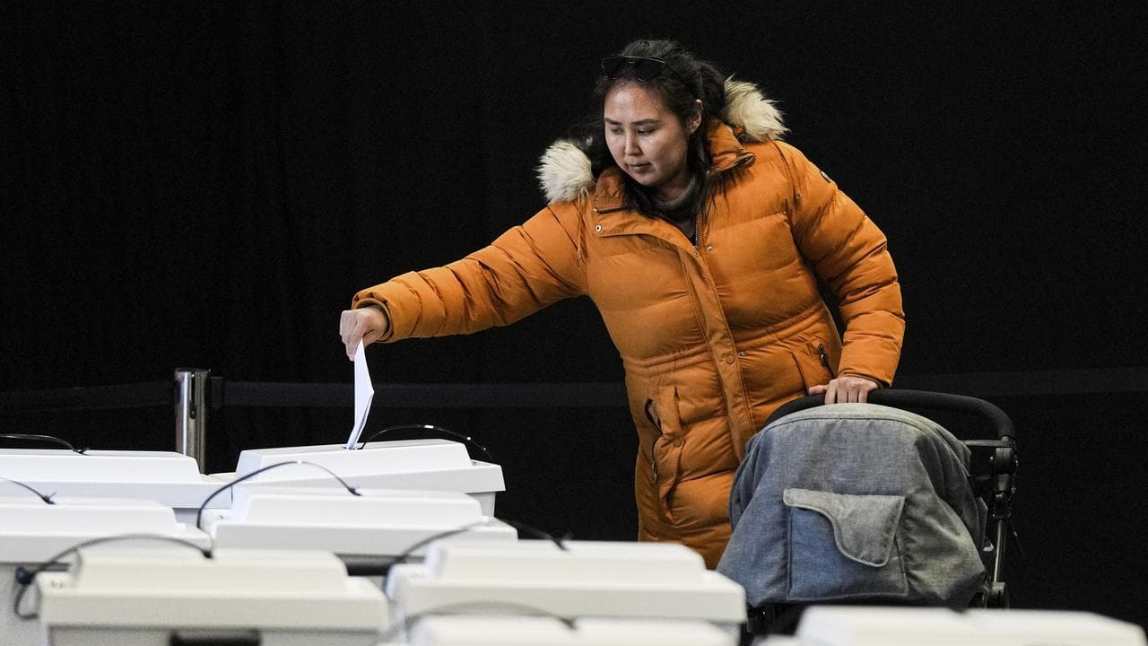 A woman votes in the Greenland election