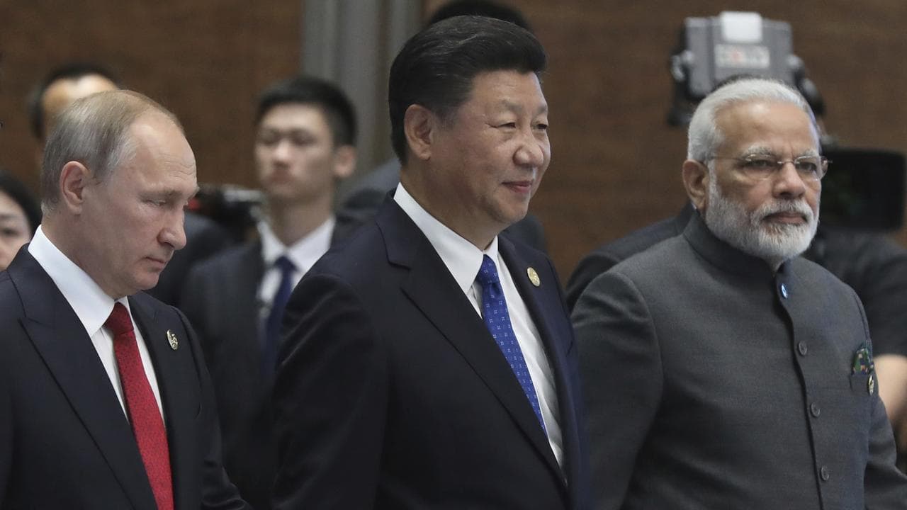 Vladimir Putin, left,  Xi Jinping, center, and Narendra Modi