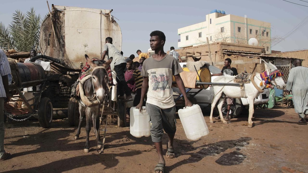 People gather to collect water in Sudan (file image)