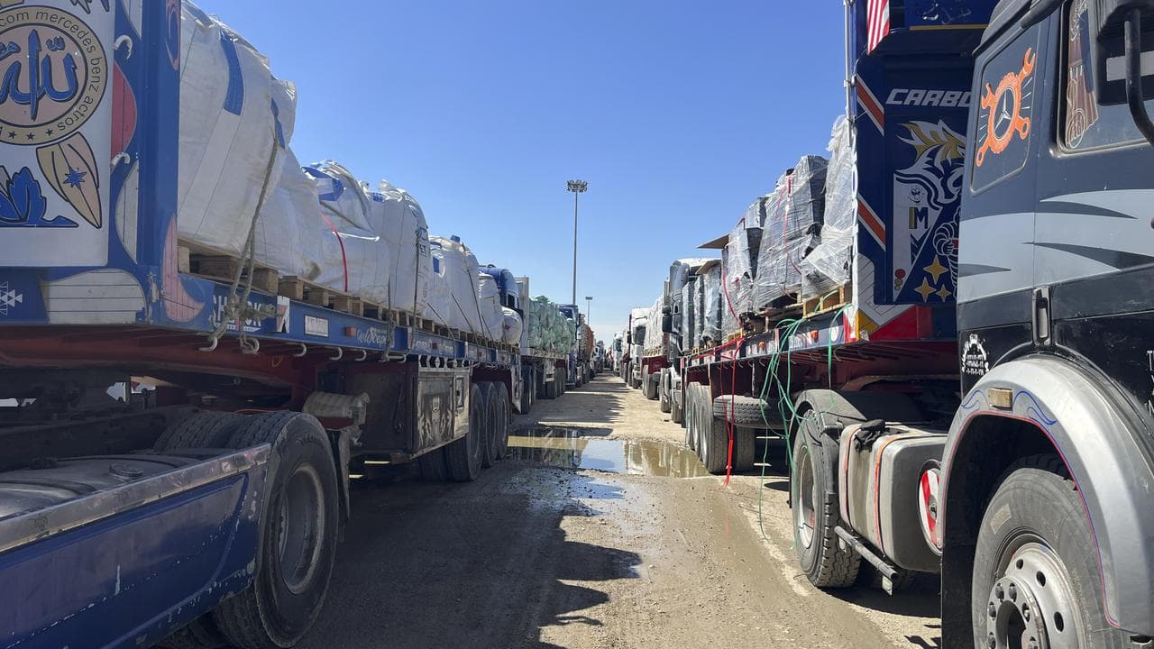 Trucks line up at the Egyptian side of the Rafah border