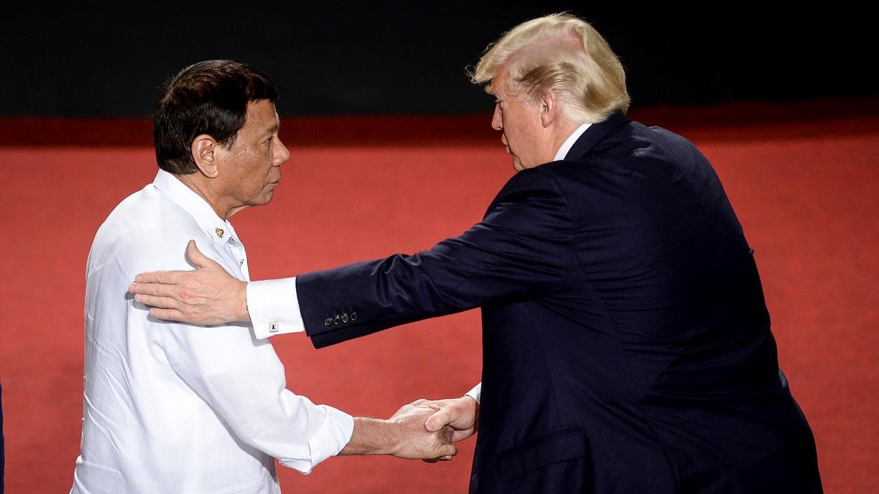 Trump shaking hands with then Philippine President Rodrigo Duterte,