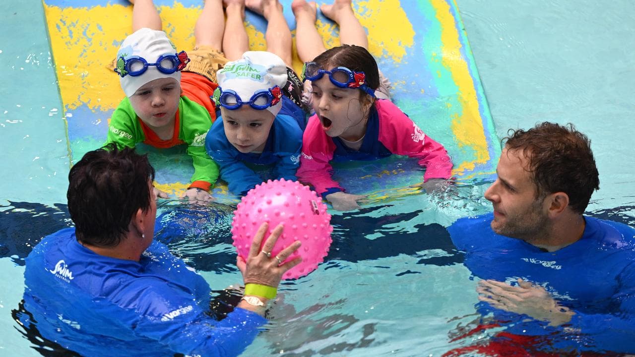 Children take part in a swimming lesson