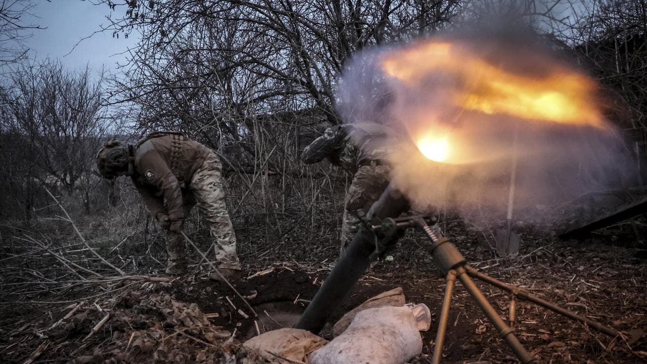 Ukrainian soldiers fire a mortar at Russian army positions in Donetsk