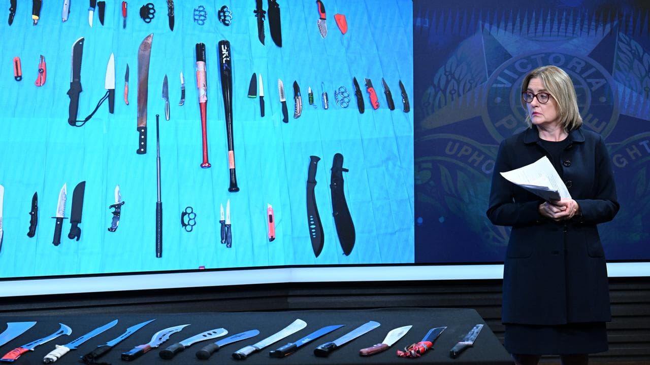 Premier Jacinta Allan looks at a display of weapons at a police event