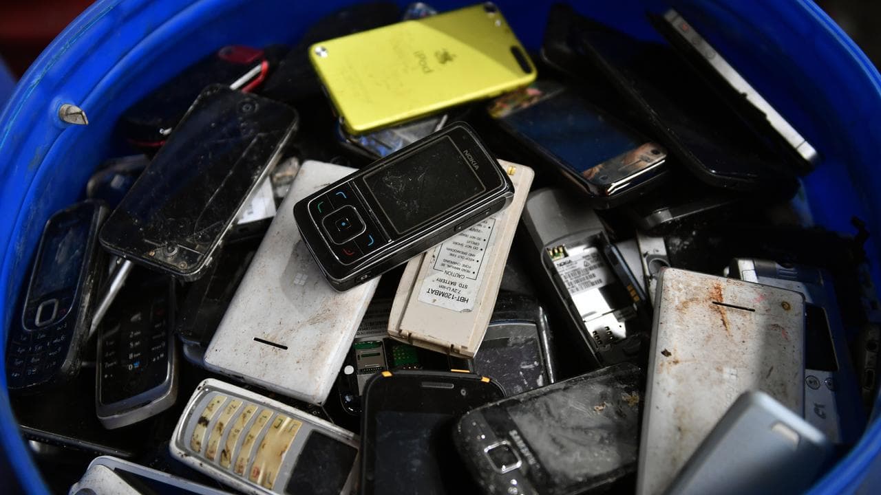 Mobile phones in a bin