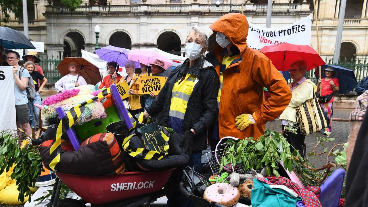 Demonstrators with waterlogged items outside Queensland Parliament