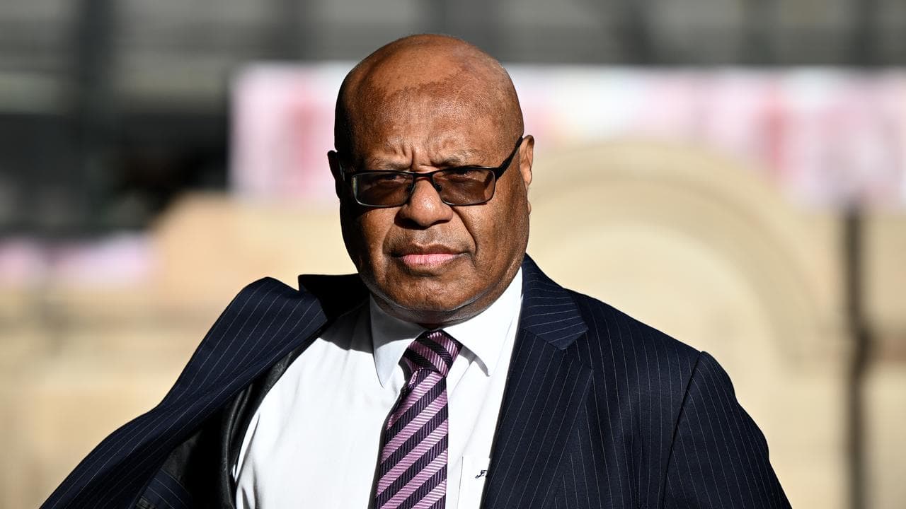 Jimmy Maladina (right) arrives at the Downing Centre Local Court