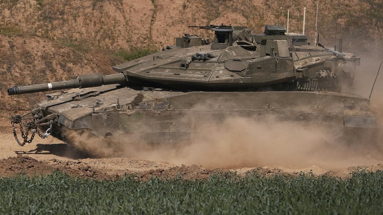 An Israeli tank manoeuvres on the Gaza Strip border in southern Israel