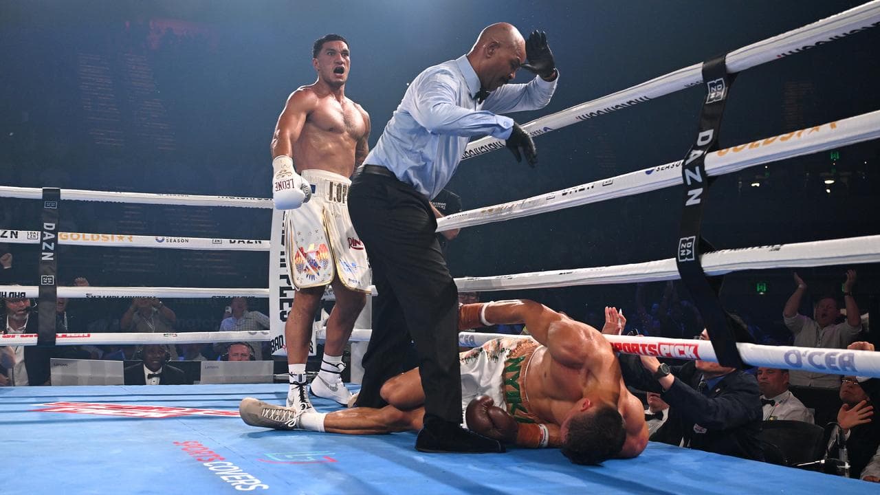 Jai Opetaia (left) stands by as the referee counts out David Nyika.