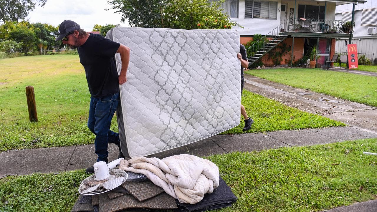 A resident cleaning up their house after floods in Brisbane