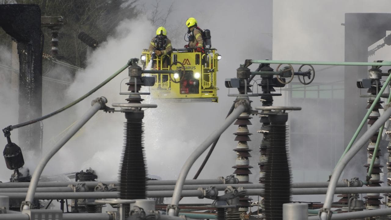 Firefighters extinguish a fire at a substation in London