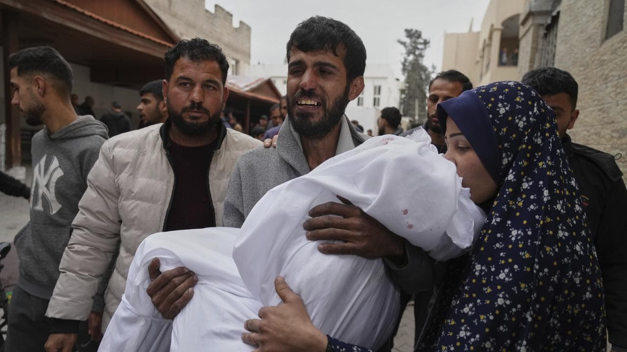 Palestinian man carries the body of his daughter in Gaza City