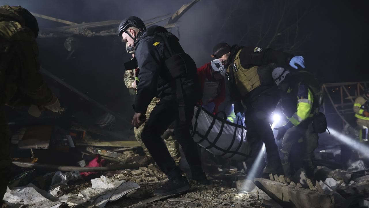 Police carry a body after a Russian drone strike in Zaporizhzhia