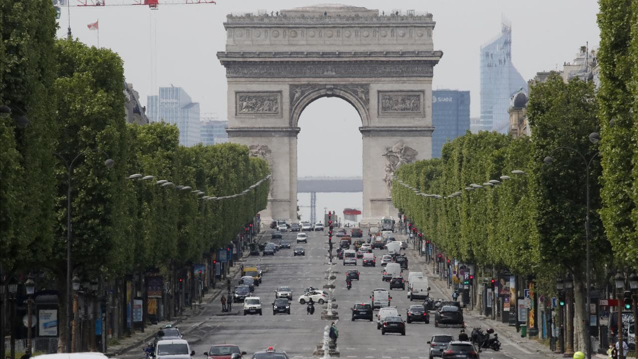 Cars drive on the Champs Elysee avenue