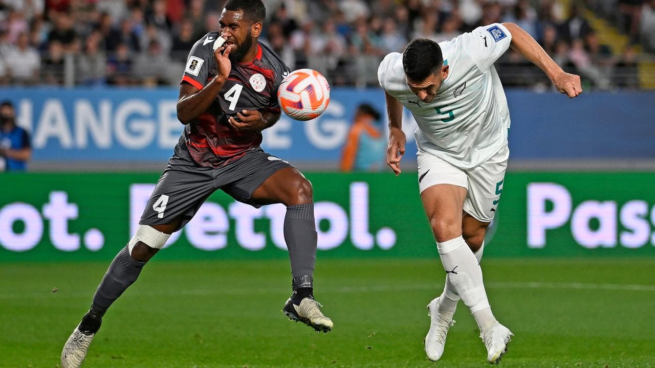 New Caledonia’s Pierre Bako and New Zealand’s Michael Boxall.