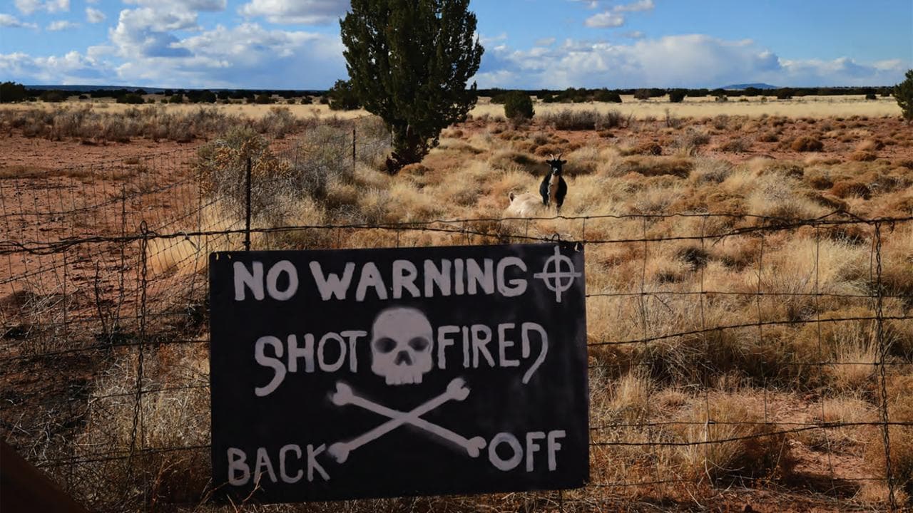 Sign stating 'no warning shot' will be fired at the  Arizona property 