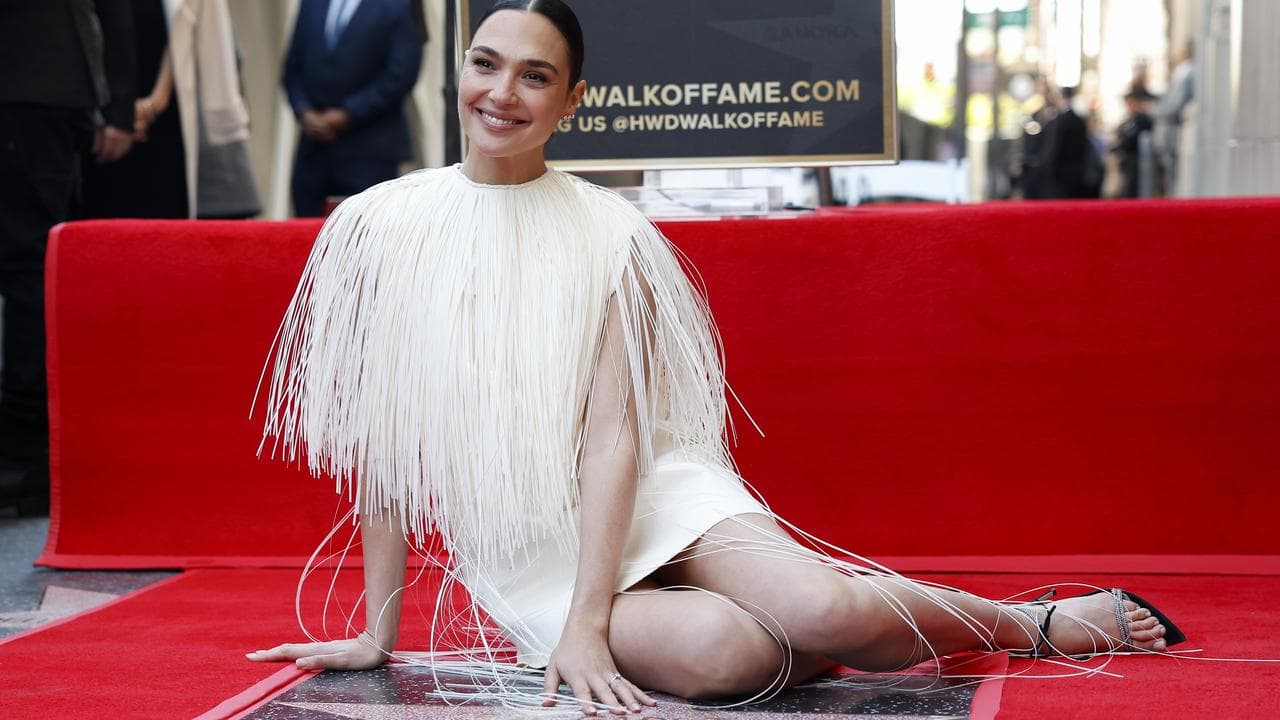 Gal Gadot sits by her Hollywood Walk of Fame star, 18 March 2025