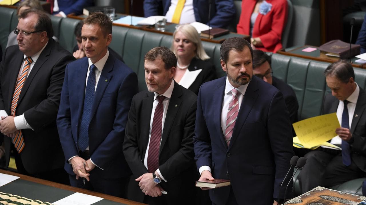 Ed Husic holding a Koran.