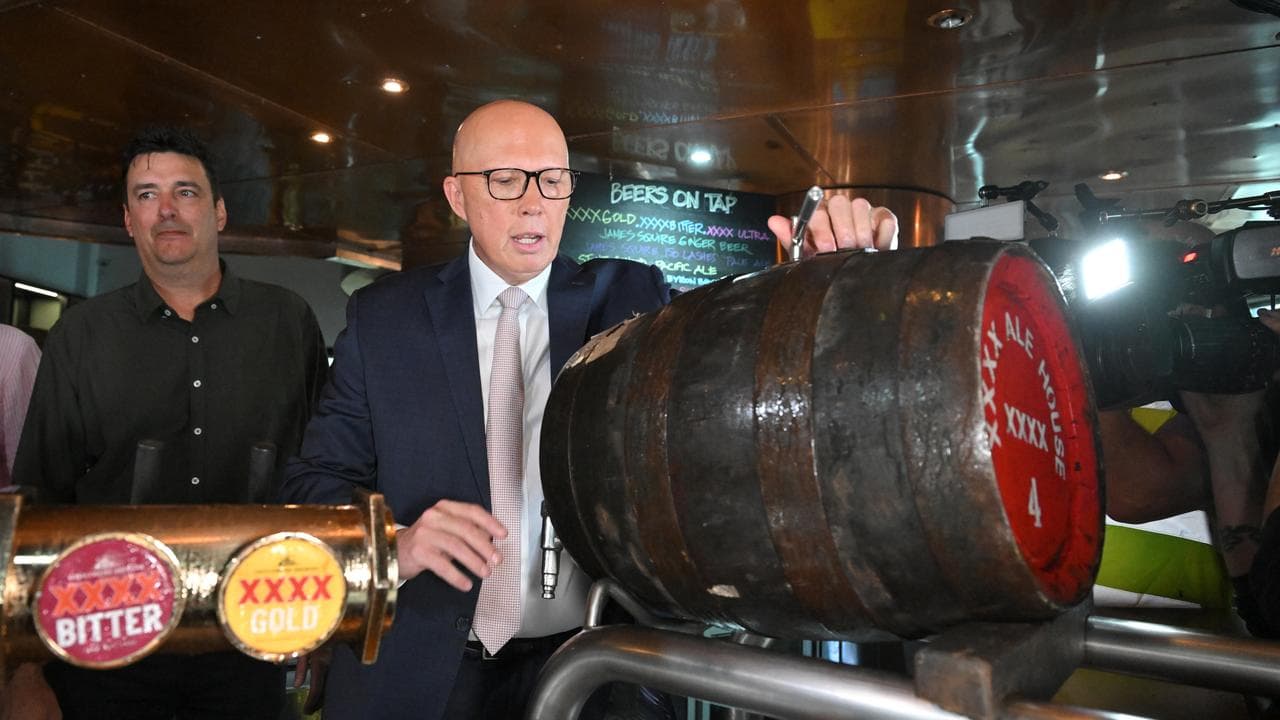 Opposition Leader Peter Dutton pours a beer at the XXXX brewery