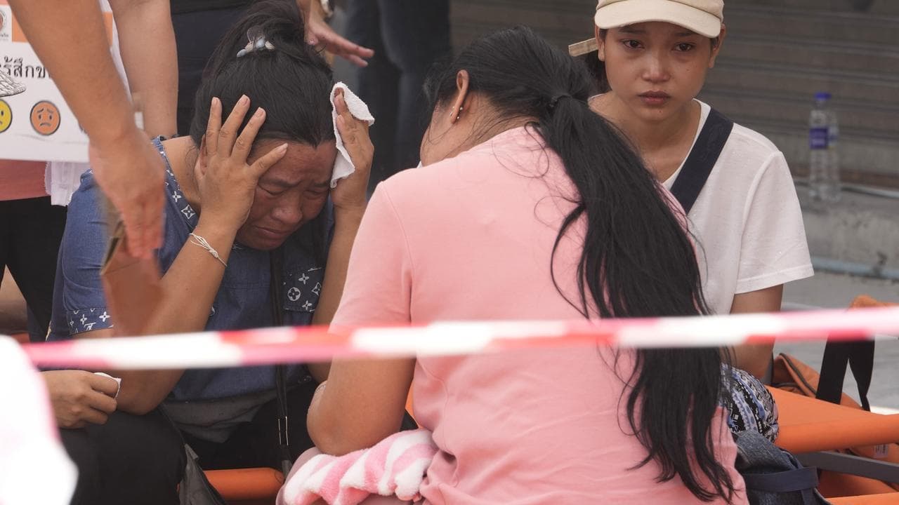 A woman cries at the site of a collapsed high-rise in Bangkok
