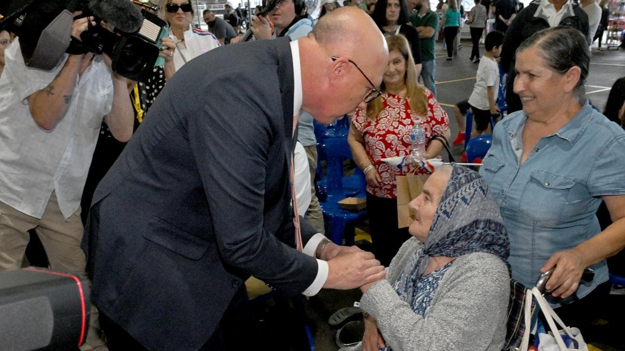 Peter Dutton speaks to an old lady