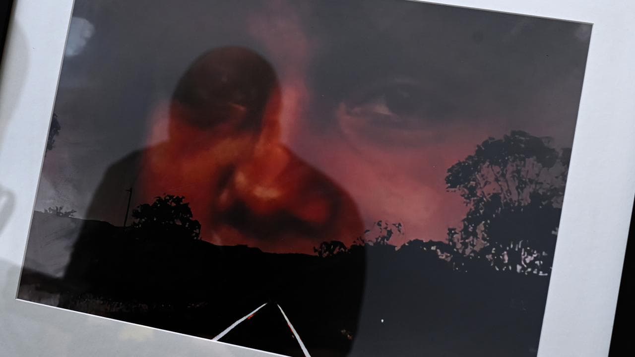 Portrait of Mark Haines behind train tracks