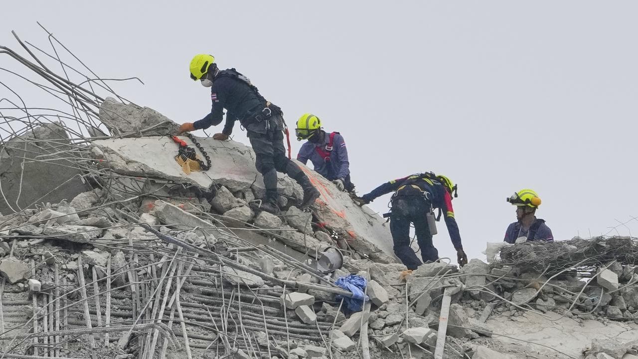 Rescuers look for signs of life in a collapsed tower in Bangkok