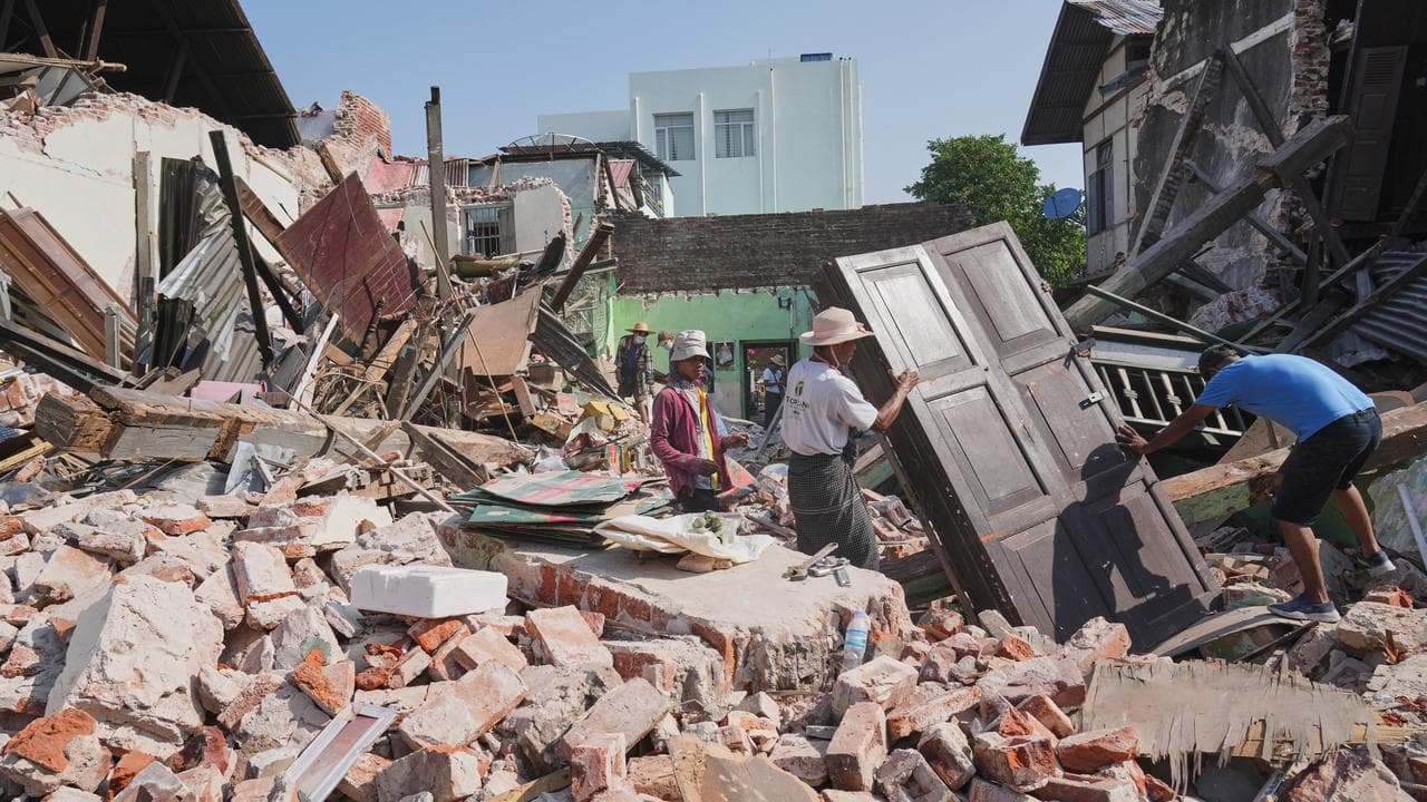 People carry their belongings after a quake in Naypyitaw, Myanmar